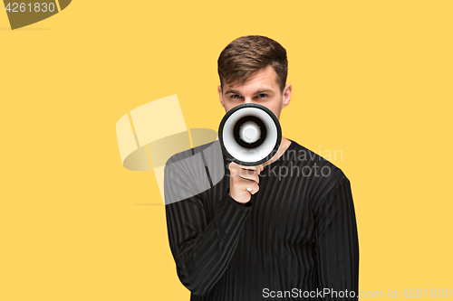 Image of The young man holding a megaphone