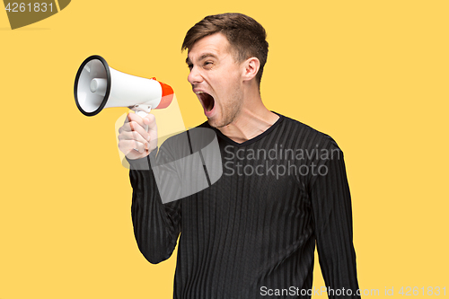 Image of The young man holding a megaphone