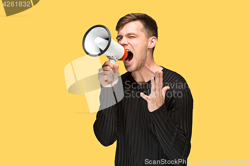 Image of The young man holding a megaphone