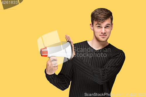 Image of The young man holding a megaphone