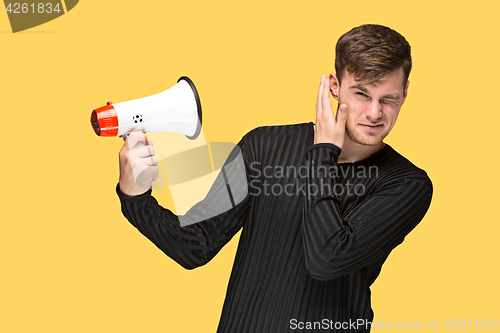 Image of The young man holding a megaphone
