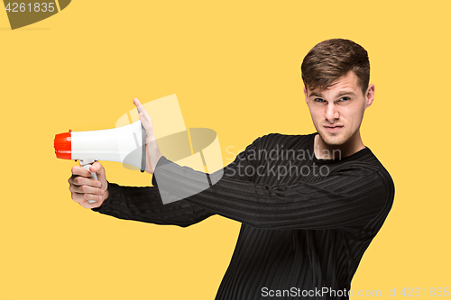 Image of The young man holding a megaphone