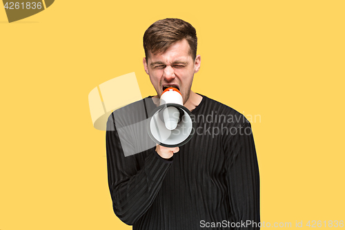 Image of The young man holding a megaphone