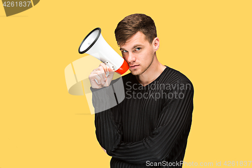 Image of The young man holding a megaphone