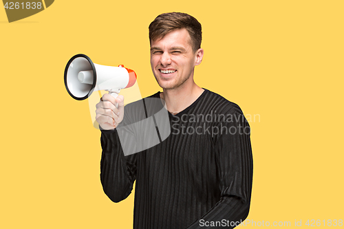 Image of The young man holding a megaphone