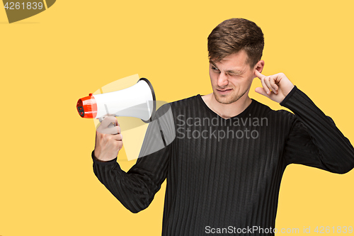 Image of The young man holding a megaphone