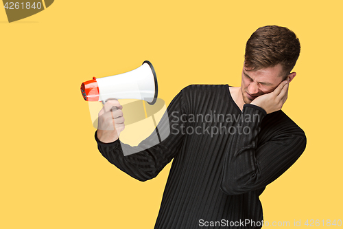 Image of The young man holding a megaphone