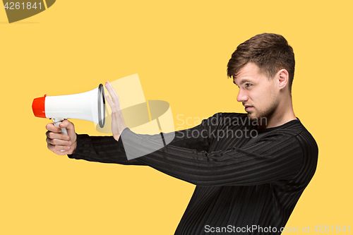 Image of The young man holding a megaphone