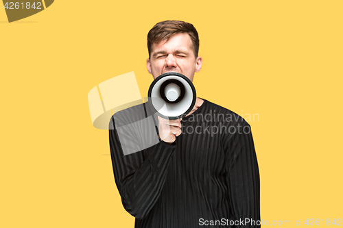Image of The young man holding a megaphone