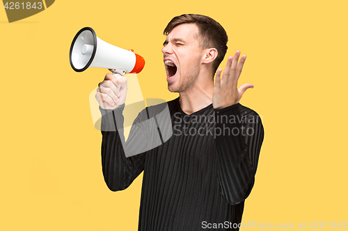 Image of The young man holding a megaphone