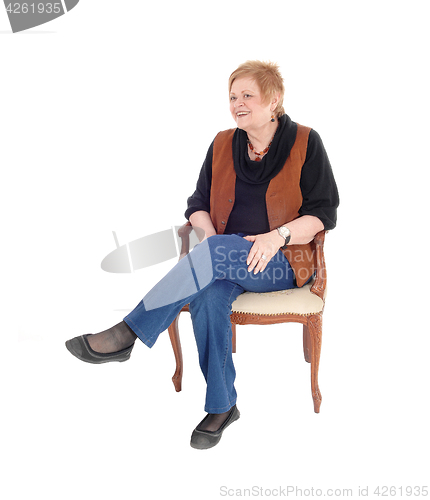Image of Senior woman relaxing, sitting.