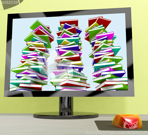 Image of Three Stacks Of Books On Computer Shows Online Learning