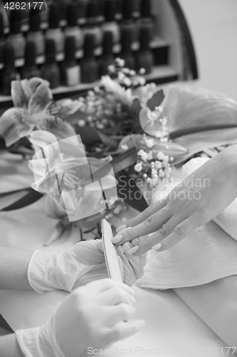 Image of Woman hands receiving a manicure