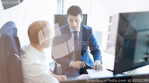 Image of Two businessmen discussing a bisiness problem at meeting in trading office.