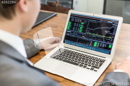 Image of Young businessman working with laptop, man\'s hands on notebook computer.