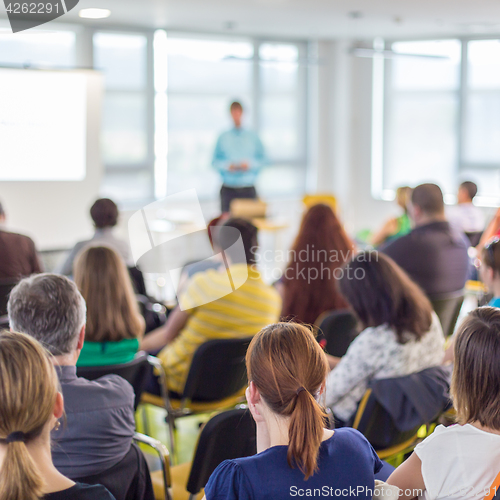 Image of Speaker giving presentation on business conference.