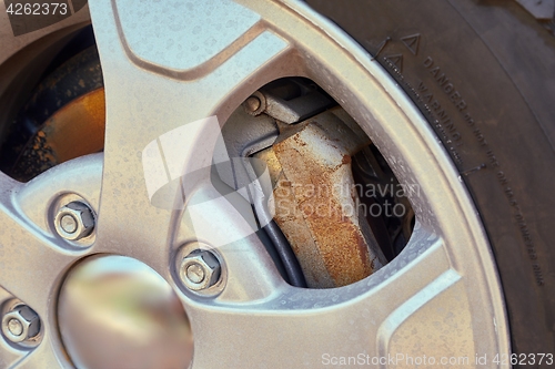 Image of Wheel closeup with rusty brakediscs