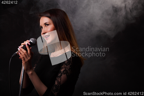 Image of Singing brunette background of smoke