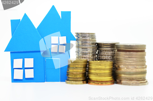 Image of House model and stacks of coins