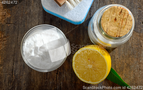 Image of Tools with lemon and sodium bicarbonate on wood