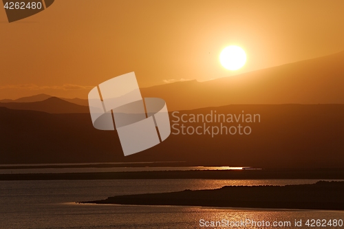 Image of Sunset with Lake and Hilly Landscape