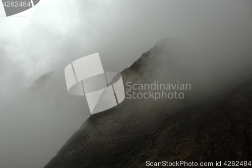 Image of Mountain cliffs in fog