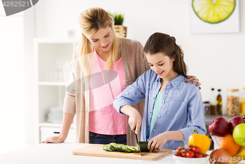 Image of happy family cooking dinner at home kitchen