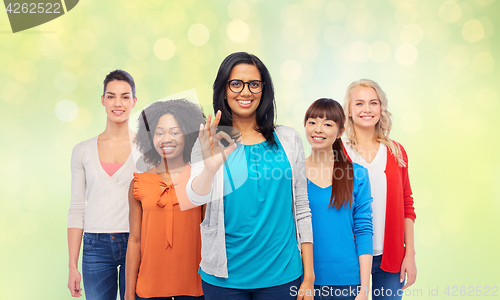 Image of international group of happy women showing ok