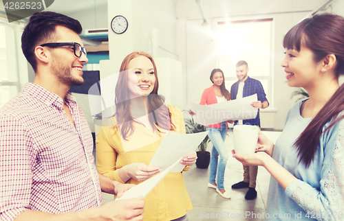 Image of creative team on coffee break talking at office