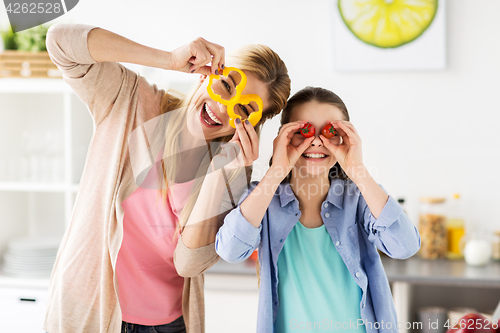 Image of happy family cooking and having fun at kitchen