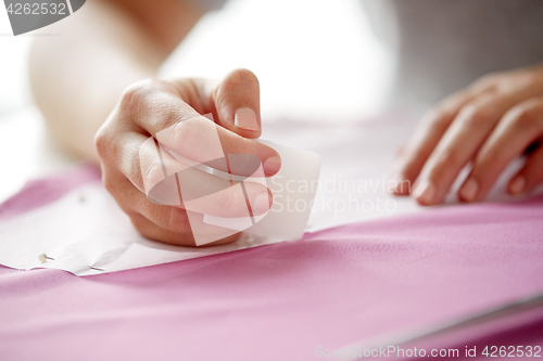 Image of woman with pattern and chalk drawing on fabric