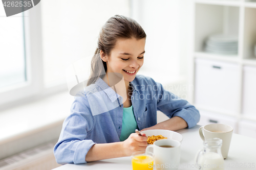 Image of happy girl having breakfast at home kitchen