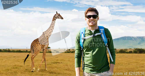 Image of happy young man with backpack traveling in africa