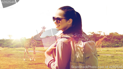 Image of happy woman with backpack traveling in africa