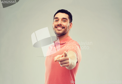 Image of man pointing finger to you over gray background