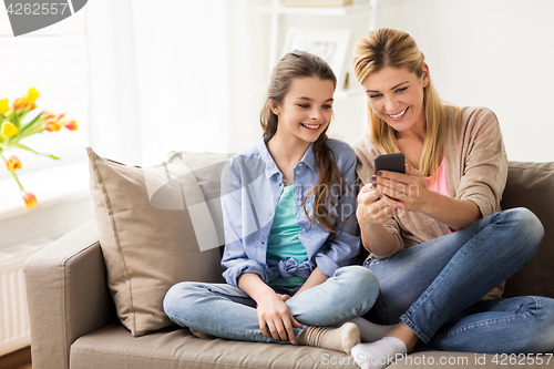 Image of happy family with smartphone at home