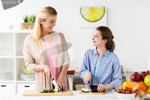 Image of happy family cooking dinner at home kitchen