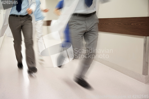 Image of close up of medics or doctors running at hospital