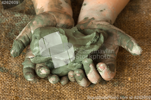 Image of blue clay in the hands of child