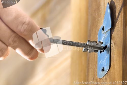 Image of hands unlocking door, closeup