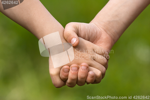 Image of hands of two children, friendship concept