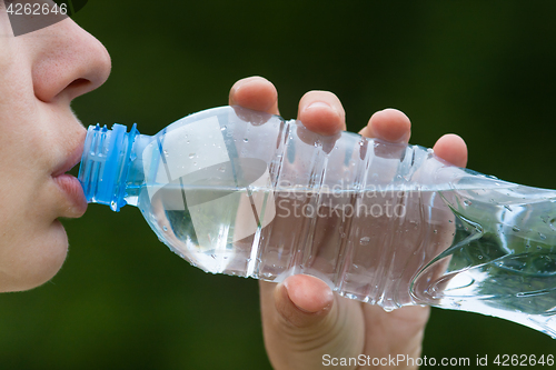 Image of woman drinking water from a bottle