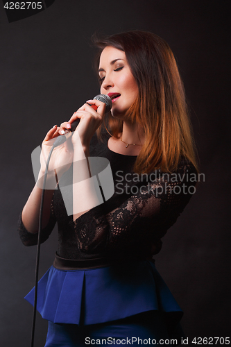 Image of Long hair brunette with microphone