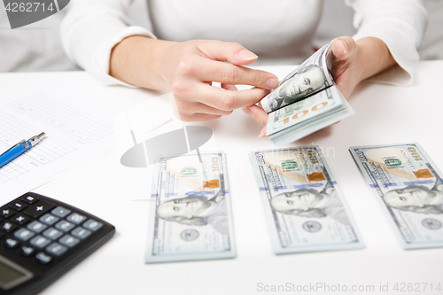 Image of Hands counting money, close up