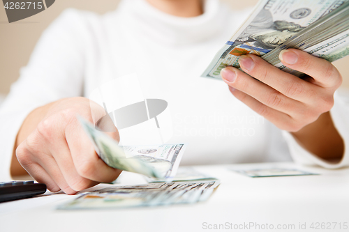 Image of Hands counting money, close up