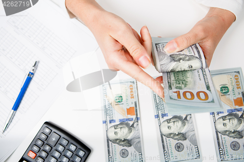 Image of Hands counting money, close up