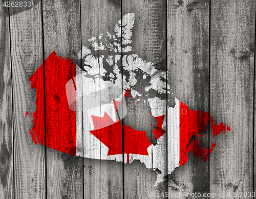 Image of Map and flag of Canada on weathered wood