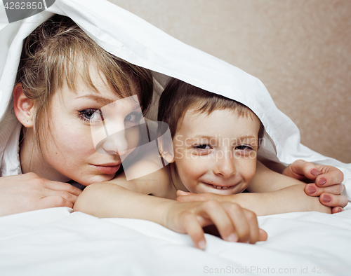 Image of young blond woman with little boy in bed, mother and son, happy familyyoung blond woman with little boy in bed, mother and son, happy family