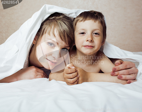 Image of young blond woman with little boy in bed, mother and son, happy familyyoung blond woman with little boy in bed, mother and son, happy family