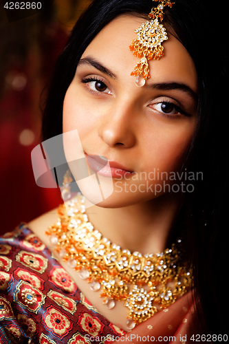 Image of beauty sweet real indian girl in sari smiling on black backgroun